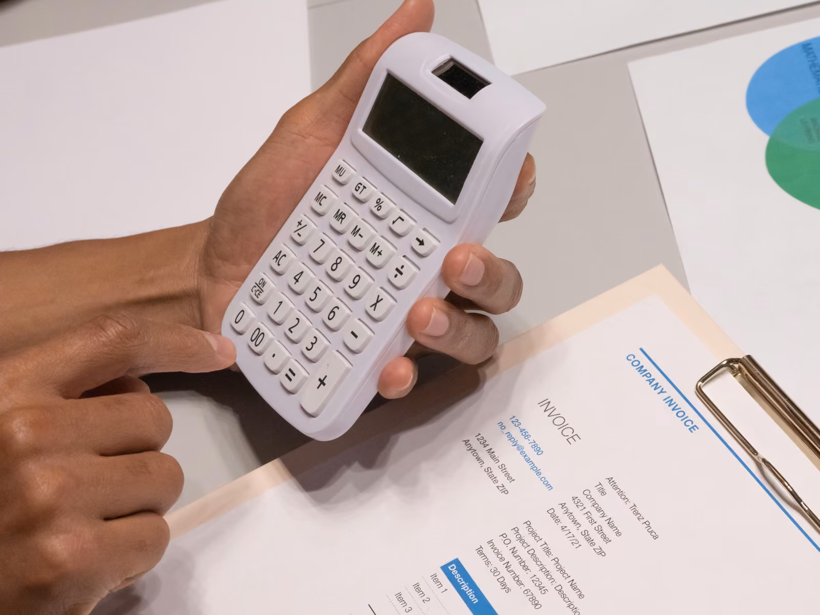 A business invoice and calculator on a desk