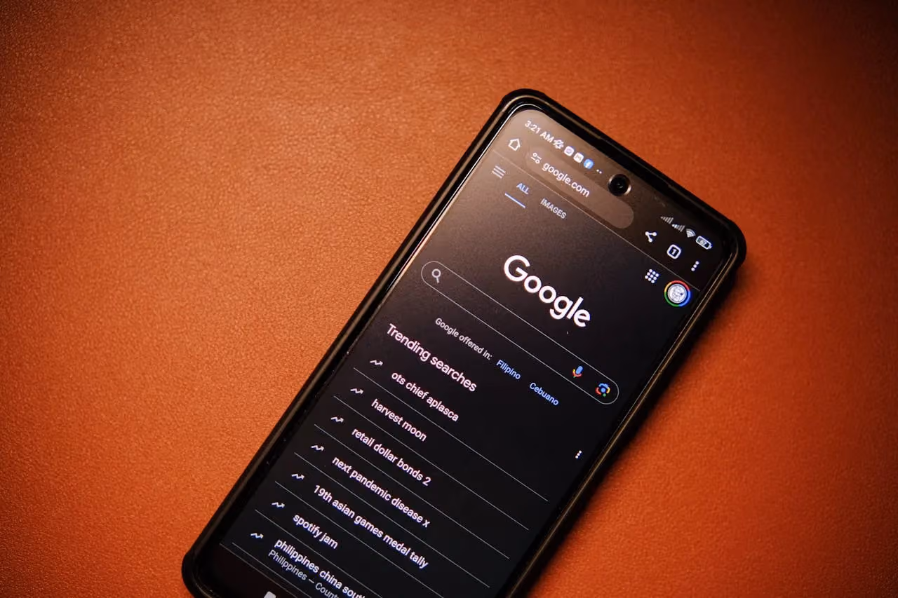 Smartphone displaying Google search results on an orange background