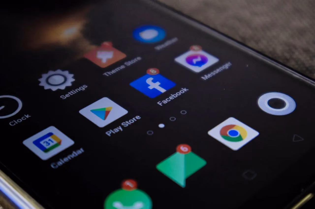 Close-up of smartphone screen showing mobile apps including social media and search