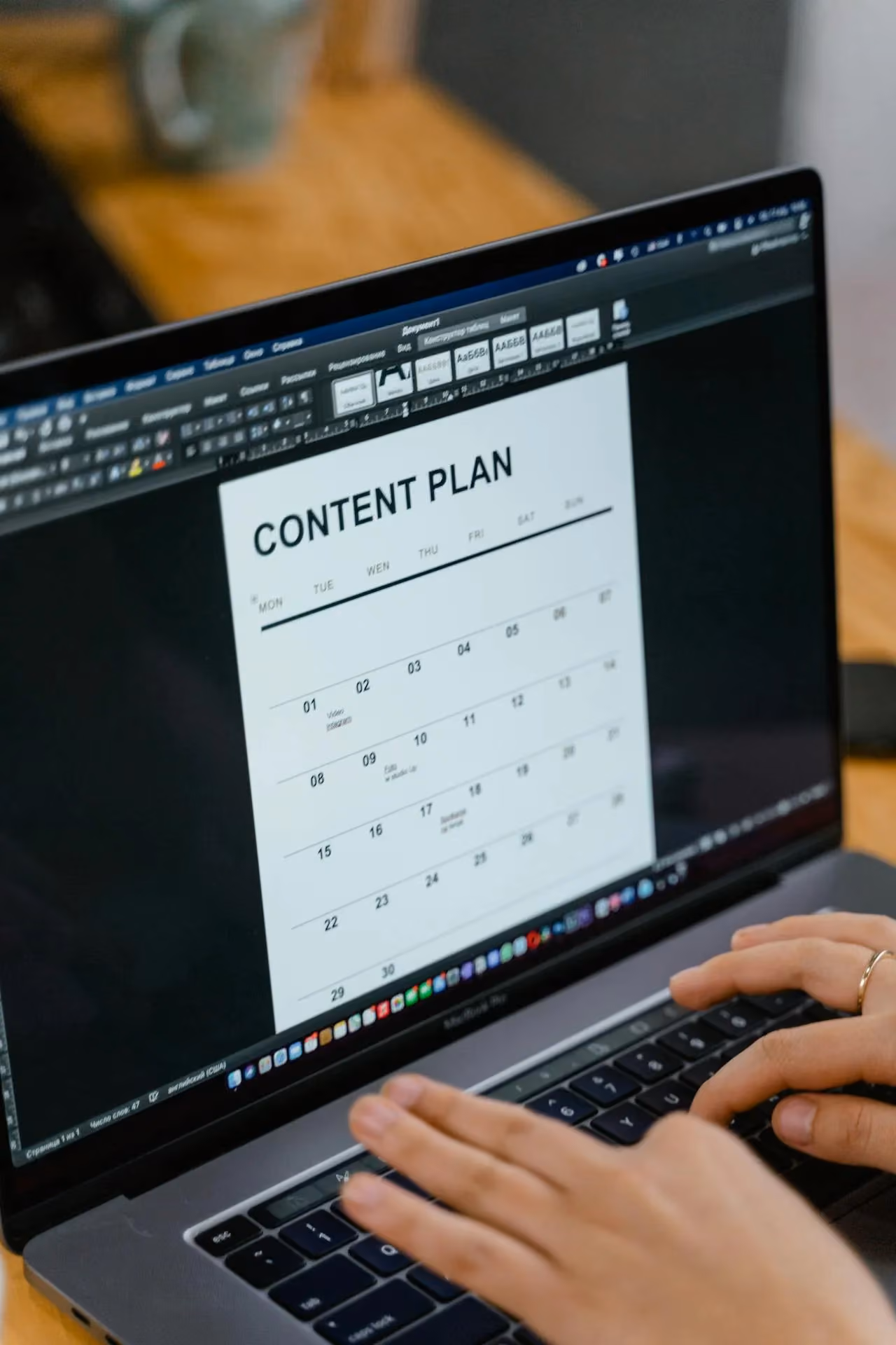 A person writing a content plan at their desk, illustrating the preparation work that goes into a good web design brief