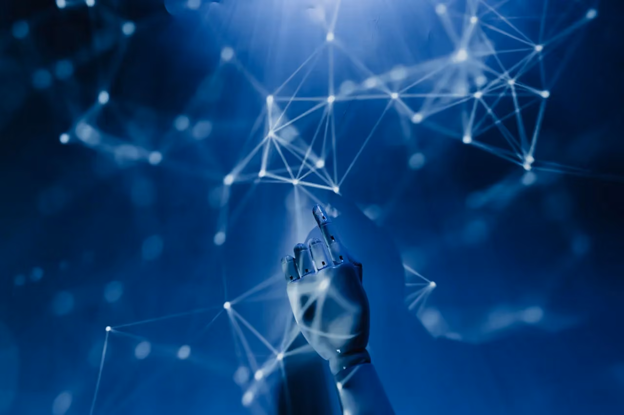 Robotic hand reaching toward a network of connected data points, representing artificial intelligence