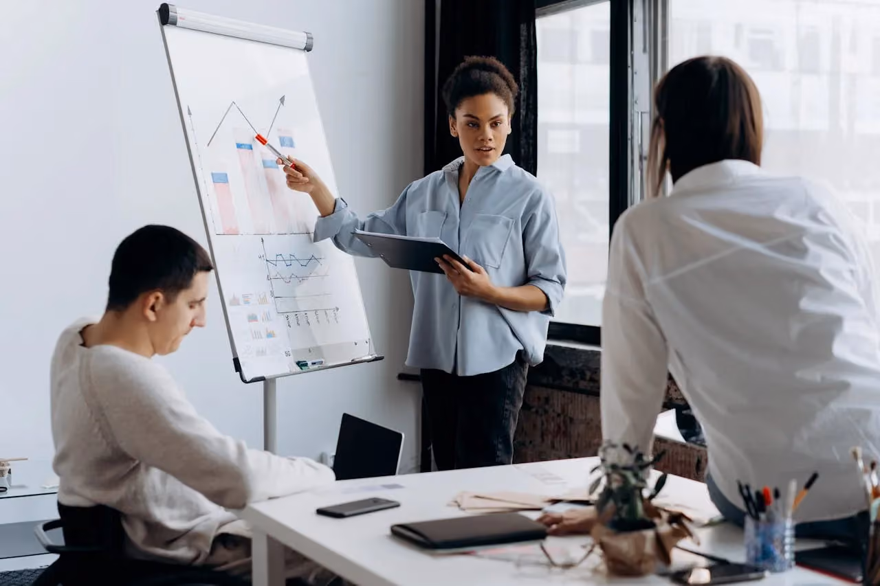 Woman presenting project results to colleagues during a business meeting
